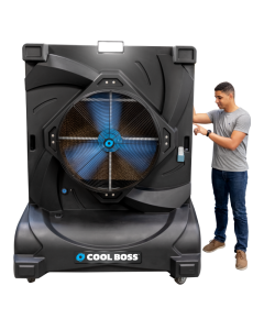 Man standing beside Cool Boss CB-36 portable indoor/outdoor evaporative air cooler — space-saving shop-fan with Blue Flex™ axial-flow fan and LED floodlight.