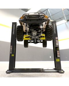 BendPak 5920150 two-post lift raising a tan RC Toyota off-road vehicle, showcasing the lift’s stability and rugged build for die-cast scale models.