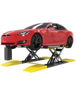 BendPak MDS-6EXT 5175192 6,000-lb extended-platform mid-rise scissor lift raising a red Tesla from the front-right angle, showing long platforms and yellow approach ramps.
