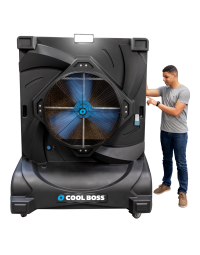 Man standing beside Cool Boss CB-36 portable indoor/outdoor evaporative air cooler — space-saving shop-fan with Blue Flex™ axial-flow fan and LED floodlight.