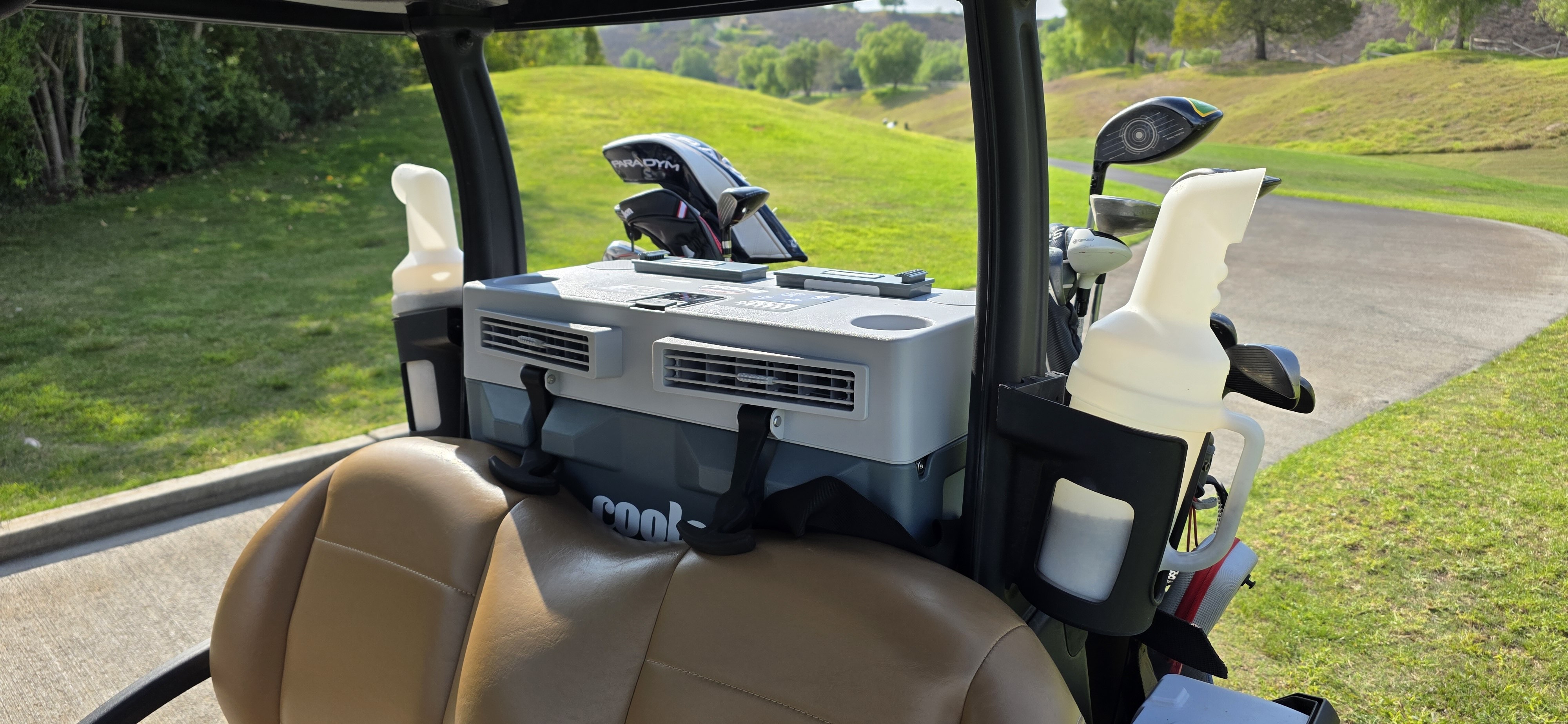 Engineered for golf carts, the Coolee Tour LX is a portable micro air-conditioning system that delivers cold, dry air—up to 35 degrees cooler than the ambient temperature—directly to the driver and passenger