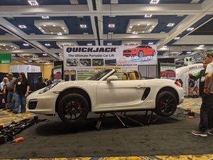 White Porsche at BendPak's indoor booth SEMA 2019